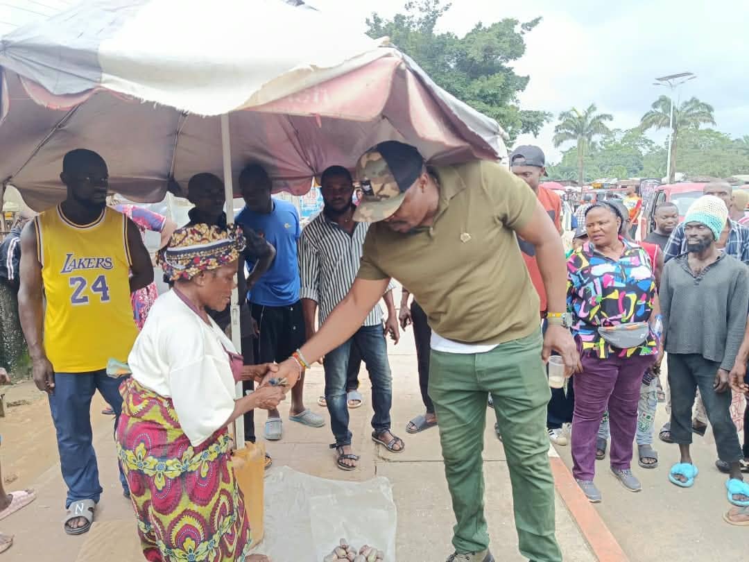 A council official greeting a market woman